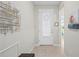 A bright foyer with tile flooring, decorative wall art and a glimpse into other rooms in the home at 1470 Hyssop Loop, North Port, FL 34289