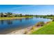 Picturesque lake view with lush greenery, offering a tranquil and serene backdrop for the community at 1470 Hyssop Loop, North Port, FL 34289