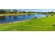 Scenic lake view surrounded by lush greenery, showcasing the community's tranquil and picturesque setting at 1470 Hyssop Loop, North Port, FL 34289