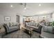 Inviting living room with comfortable seating, modern decor, and an open layout to kitchen at 1470 Hyssop Loop, North Port, FL 34289