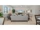 Spacious living room with neutral tones, comfortable seating, and a large window with plantation shutters at 1470 Hyssop Loop, North Port, FL 34289