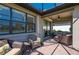 Inviting covered patio featuring comfortable seating, ceiling fan, and stylish brick flooring for relaxing outdoors at 1470 Hyssop Loop, North Port, FL 34289