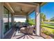 Screened patio featuring outdoor furniture, ceiling fan, with a view of pond at 1470 Hyssop Loop, North Port, FL 34289