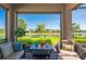 A patio featuring comfortable seating and a view of a lake and green landscape at 1470 Hyssop Loop, North Port, FL 34289