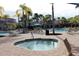Relaxing community pool area with palm trees, lounge chairs, and a hot tub for unwinding at 1470 Hyssop Loop, North Port, FL 34289