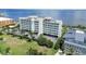 Gorgeous aerial view of the condo building with lush grounds and bay views at 1500 Park Beach Cir # 5E, Punta Gorda, FL 33950
