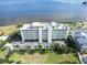 Stunning aerial view showcasing a condo building with a rooftop pool overlooking the bay at 1500 Park Beach Cir # 5E, Punta Gorda, FL 33950