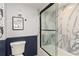 Charming bathroom features tiled shower with glass doors, framed with sleek black accents at 1500 Park Beach Cir # 5E, Punta Gorda, FL 33950