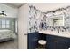 Stylish bathroom with elegant wallpaper and adjacent bedroom in tranquil color palette at 1500 Park Beach Cir # 5E, Punta Gorda, FL 33950