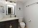The half-bath features modern lighting, sink, toilet, and decorative nautical artwork at 1500 Park Beach Cir # 5E, Punta Gorda, FL 33950