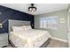 Relaxing bedroom with navy accent wall, plush bedding, and shuttered windows overlooking a scenic view at 1500 Park Beach Cir # 5E, Punta Gorda, FL 33950