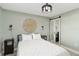 This bedroom features minimalist decor, a queen bed, and mirrored closet doors at 1500 Park Beach Cir # 5E, Punta Gorda, FL 33950