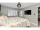Sunlit bedroom with calming wall color, leading to outdoor views, and showcasing mounted TV at 1500 Park Beach Cir # 5E, Punta Gorda, FL 33950