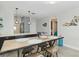 An elegant dining area showcasing a rustic wooden table, stylish chairs and decor in a bright, open setting at 1500 Park Beach Cir # 5E, Punta Gorda, FL 33950