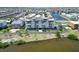 Aerial view of white condo complex featuring waterfront views and community amenities at 1500 Park Beach Cir # 5E, Punta Gorda, FL 33950