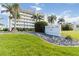 Beautiful white building Palacio Del Sol 1500 with tropical landscaping and palm trees at 1500 Park Beach Cir # 5E, Punta Gorda, FL 33950