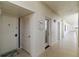 Hallway leading to unit #5, with well-maintained neutral walls and lighting at 1500 Park Beach Cir # 5E, Punta Gorda, FL 33950