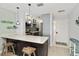 An open kitchen with barstool seating, modern stainless appliances, light colored walls and flooring offering a clean, bright space at 1500 Park Beach Cir # 5E, Punta Gorda, FL 33950