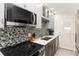 A contemporary kitchen showcasing a modern stove top, stainless steel appliances and backsplash creating a sleek aesthetic at 1500 Park Beach Cir # 5E, Punta Gorda, FL 33950