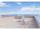 Expansive rooftop deck with lounge chairs, offering stunning views of the water at 1500 Park Beach Cir # 5E, Punta Gorda, FL 33950