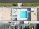 Aerial view of a building rooftop pool with lounge chairs and umbrellas for relaxing and enjoying the sun at 1500 Park Beach Cir # 5E, Punta Gorda, FL 33950