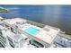 A rooftop pool with lounge chairs offers stunning water views and an American flag flying proudly at 1500 Park Beach Cir # 5E, Punta Gorda, FL 33950