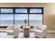 Bay views from a seating area in the living room with two white swivel chairs at 1500 Park Beach Cir # 5E, Punta Gorda, FL 33950