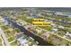 Stunning aerial view of a home with sail boat access to the canal at 15698 Meacham Cir, Port Charlotte, FL 33981