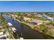 Scenic aerial view of a waterfront home with canal access and lush surroundings at 15698 Meacham Cir, Port Charlotte, FL 33981
