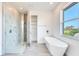 Spa-like bathroom with soaking tub, frameless shower, and a large window for natural light at 15698 Meacham Cir, Port Charlotte, FL 33981