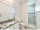Bright bathroom featuring single granite vanity and walk-in shower at 15698 Meacham Cir, Port Charlotte, FL 33981