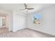 Well-lit bedroom with a large closet and a view of the tropical landscape at 15698 Meacham Cir, Port Charlotte, FL 33981