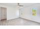 Well-lit bedroom featuring wood-look tile floors and dual closets at 15698 Meacham Cir, Port Charlotte, FL 33981