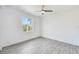Bright bedroom with light gray flooring and a ceiling fan at 15698 Meacham Cir, Port Charlotte, FL 33981