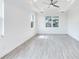 Airy bedroom filled with natural light from three windows, enhanced by modern ceiling fan at 15698 Meacham Cir, Port Charlotte, FL 33981