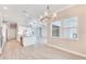 Open dining area featuring contemporary chandelier, lots of light, and views of the modern kitchen and open floor plan at 15698 Meacham Cir, Port Charlotte, FL 33981