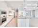 Modern kitchen featuring stainless steel appliances, a spacious island with granite countertops, and ample cabinet space at 15698 Meacham Cir, Port Charlotte, FL 33981