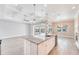 Bright, open kitchen featuring a large island, stainless steel appliances, and a view to the screened-in pool outside at 15698 Meacham Cir, Port Charlotte, FL 33981