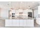 Close up of spacious kitchen island with white cabinets and granite countertops, complemented by modern stainless appliances at 15698 Meacham Cir, Port Charlotte, FL 33981