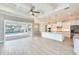 Open-concept living room and kitchen with modern finishes and access to the pool area at 15698 Meacham Cir, Port Charlotte, FL 33981