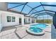 Screened-in pool and spa with brick paver deck and covered patio at 15698 Meacham Cir, Port Charlotte, FL 33981