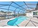 Screened-in pool and spa overlooking the canal, offering a private oasis at 15698 Meacham Cir, Port Charlotte, FL 33981