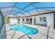 Gorgeous covered pool featuring brick pavers and a built-in spa at 15698 Meacham Cir, Port Charlotte, FL 33981
