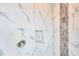 Walk-in shower featuring marble tile, mosaic accents and a shower niche at 15698 Meacham Cir, Port Charlotte, FL 33981