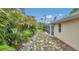 View of the backyard surrounded by palm trees and a lush lawn, perfect for outdoor living at 1761 Okolona St, North Port, FL 34287