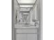 Modern bathroom featuring a white vanity with a large mirror and ample storage at 1761 Okolona St, North Port, FL 34287