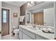 Well-lit bathroom showcasing a white vanity with a large mirror and ample countertop space at 1761 Okolona St, North Port, FL 34287