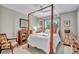 Bedroom with a canopy bed, natural light, ceiling fan, and hardwood floors at 1761 Okolona St, North Port, FL 34287