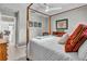 Comfortable bedroom showcasing a wooden four-poster bed and stylish decor at 1761 Okolona St, North Port, FL 34287