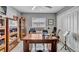 Bedroom with a large window, ceiling fan, and used as an office with wooden desk and bookshelves at 1761 Okolona St, North Port, FL 34287